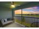 Relaxing screened lanai offers a ceiling fan and seating with panoramic sunset views over the water at 14224 Heritage Landing Blvd # 923, Punta Gorda, FL 33955