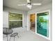 Covered patio with view of lake, chairs, sliding glass door and outside dining area at 14224 Heritage Landing Blvd # 923, Punta Gorda, FL 33955
