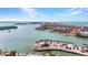 Stunning aerial view of a waterfront area with a pier, boats, and homes, offering beautiful scenery at 1701 Beach Rd # 305, Englewood, FL 34223