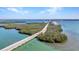 Expansive aerial view of a coastal bridge surrounded by lush greenery and serene ocean waters, offering stunning scenery at 1701 Beach Rd # 305, Englewood, FL 34223
