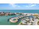 Stunning aerial view of a waterfront community, featuring a marina, beach access, and tropical landscaping at 1701 Beach Rd # 305, Englewood, FL 34223
