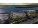 Aerial view of condo buildings with water views and palm trees, showcasing the waterfront property at 1701 Beach Rd # 305, Englewood, FL 34223