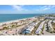 Breathtaking aerial view showcasing a pristine sandy beach, charming coastal homes, and picturesque oceanfront access at 1701 Beach Rd # 305, Englewood, FL 34223
