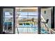 Inviting screened condo balcony with bar-height seating overlooks a tranquil ocean view at 1701 Beach Rd # 305, Englewood, FL 34223