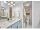 Bathroom with a white countertop, blue vanity, updated mirror and vanity lights, and a view into the toilet room at 1701 Beach Rd # 305, Englewood, FL 34223