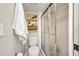 Bathroom featuring a tiled shower, toilet, shelving, and a towel on a towel bar at 1701 Beach Rd # 305, Englewood, FL 34223