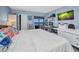 Light blue bedroom with a king bed, an exterior view, and a desk with a television, printer, and decor at 1701 Beach Rd # 305, Englewood, FL 34223