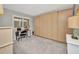 Carpeted bedroom with built in closets, a desk, a side table and a window at 1701 Beach Rd # 305, Englewood, FL 34223