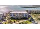 Waterfront condos with balconies, palm trees, and ample parking, creating a relaxing residential setting at 1701 Beach Rd # 305, Englewood, FL 34223