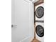Convenient laundry closet with a stacked washer and dryer, maximizing space in the home at 1701 Beach Rd # 305, Englewood, FL 34223