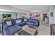 Spacious living room features a comfortable sectional sofa with open access to dining and kitchen at 1701 Beach Rd # 305, Englewood, FL 34223