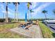 Community picnic area with a wooden picnic table and umbrella for outdoor enjoyment at 1701 Beach Rd # 305, Englewood, FL 34223