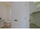 Bathroom featuring a toilet adjacent to a closet with built-in shelves at 1795 Elinor Pl, Englewood, FL 34223