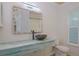 Bathroom featuring custom sink and vanity with unique seashell mirror and wood-look ceiling at 1795 Elinor Pl, Englewood, FL 34223