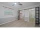 Bedroom featuring wood-look floors and a closet with mirrored doors at 1795 Elinor Pl, Englewood, FL 34223