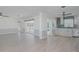 Bright and open living area seamlessly connected to the modern kitchen with views of the outdoor pool at 1795 Elinor Pl, Englewood, FL 34223