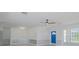 Open living area with stylish gray and white decor, a modern ceiling fan, and a bright blue entry door at 1795 Elinor Pl, Englewood, FL 34223