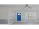 Spacious living area featuring neutral paint, a ceiling fan, and natural light from a nearby window at 1795 Elinor Pl, Englewood, FL 34223