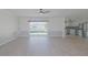 Open-concept living space with sliding glass doors to the pool and a view into the modern kitchen at 1795 Elinor Pl, Englewood, FL 34223