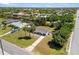 Bright waterfront home featuring an expansive lot with mature landscaping, a long driveway, and close proximity to the water at 18263 Ohara Dr, Port Charlotte, FL 33948
