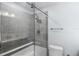 Bathroom with gray tiled shower, and modern sliding glass door and fixtures at 18263 Ohara Dr, Port Charlotte, FL 33948