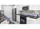 Sleek kitchen with stainless steel appliances and modern black countertops, offering a stylish cooking space at 18263 Ohara Dr, Port Charlotte, FL 33948