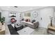 Bright living room features a modern sofa, contemporary art, and ample natural light at 18263 Ohara Dr, Port Charlotte, FL 33948