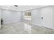 Bright and airy living room with tiled floor, offering a clean and modern space at 18263 Ohara Dr, Port Charlotte, FL 33948