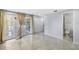 Spacious living room featuring tile floors, neutral walls, with views to the outdoor patio and bathroom at 18263 Ohara Dr, Port Charlotte, FL 33948