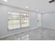 Bright living room with large window, neutral walls, and tile flooring creates a comfortable, airy feel at 18263 Ohara Dr, Port Charlotte, FL 33948