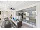 A modern patio with stylish furniture, ceiling fan, and glass sliding doors for indoor-outdoor living at 18263 Ohara Dr, Port Charlotte, FL 33948