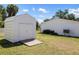A backyard view with a white storage shed, offering outdoor storage next to home at 18263 Ohara Dr, Port Charlotte, FL 33948