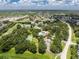 Aerial shot displays a community area with swimming pool, tennis court, and lush landscaping in a tranquil neighborhood at 20016 Sancraft Ave, Port Charlotte, FL 33954