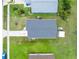 Bird's-eye view showcasing a well-maintained single-Gathering home with new roof, bordered by vibrant green landscaping at 20016 Sancraft Ave, Port Charlotte, FL 33954