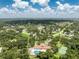 Community aerial view showcases lush greenery, swimming pool, and serene neighborhood surroundings at 20016 Sancraft Ave, Port Charlotte, FL 33954
