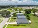 A well-maintained single-Gathering home, nestled within a community, boasts lush backyard landscaping, and mature trees at 20016 Sancraft Ave, Port Charlotte, FL 33954