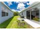 Backyard showing patio dining set, BBQ grill and sliding doors at 20016 Sancraft Ave, Port Charlotte, FL 33954