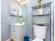 Charming bathroom with a vanity, blue trash can, and a convenient storage shelf at 20016 Sancraft Ave, Port Charlotte, FL 33954