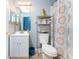 Cozy bathroom featuring a vanity, toilet, and shower with blue-themed tile and accessories at 20016 Sancraft Ave, Port Charlotte, FL 33954