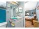 Bright bathroom with a vanity, mirror, and a doorway leading to an adjacent bedroom at 20016 Sancraft Ave, Port Charlotte, FL 33954