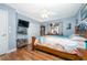 Comfortable bedroom with wood-look floors, ceiling fan, and a classic wooden bed frame at 20016 Sancraft Ave, Port Charlotte, FL 33954