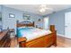 Inviting bedroom featuring wood floors, a ceiling fan, and a rustic wood bed frame at 20016 Sancraft Ave, Port Charlotte, FL 33954
