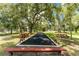 Outdoor bocce ball court with benches and picnic tables, perfect for recreational play and relaxation at 20016 Sancraft Ave, Port Charlotte, FL 33954