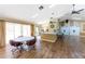 Spacious common area features a large table, kitchen access, and wood laminate floors at 20016 Sancraft Ave, Port Charlotte, FL 33954