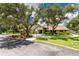 Beautiful exterior view of community building with mature trees and manicured landscaping at 20016 Sancraft Ave, Port Charlotte, FL 33954