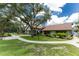 Exterior of the community building featuring landscaped grounds, a walkway, and inviting curb appeal at 20016 Sancraft Ave, Port Charlotte, FL 33954