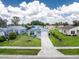 Charming single-story home with a well-manicured lawn and a driveway leading to the garage at 20016 Sancraft Ave, Port Charlotte, FL 33954