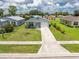 Well-maintained single-Gathering home with a manicured lawn, features an attached garage and inviting landscaping at 20016 Sancraft Ave, Port Charlotte, FL 33954