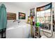 Utility room with front loading washer and dryer, tool rack, and assorted NASCAR and automotive memorabilia at 20016 Sancraft Ave, Port Charlotte, FL 33954