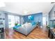 Bright living room with wood floors, large sectional couch, and sliding glass doors to the outside at 20016 Sancraft Ave, Port Charlotte, FL 33954
